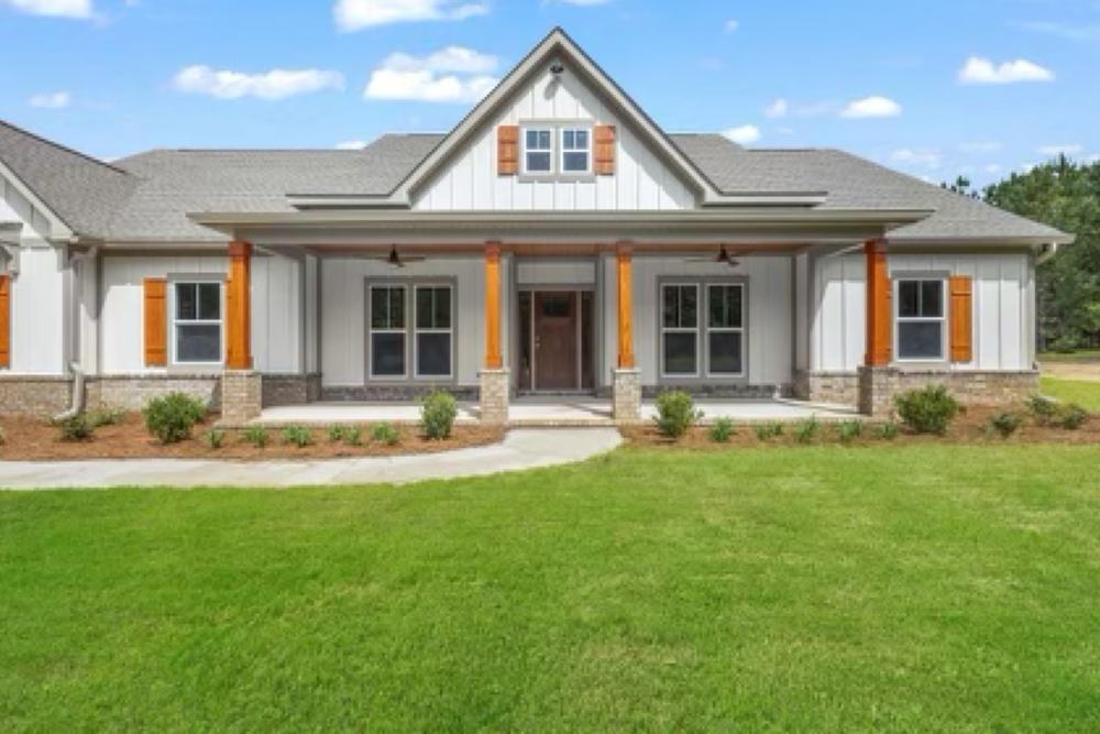 Custom farmhouse with cedar porch columns and wood shutters