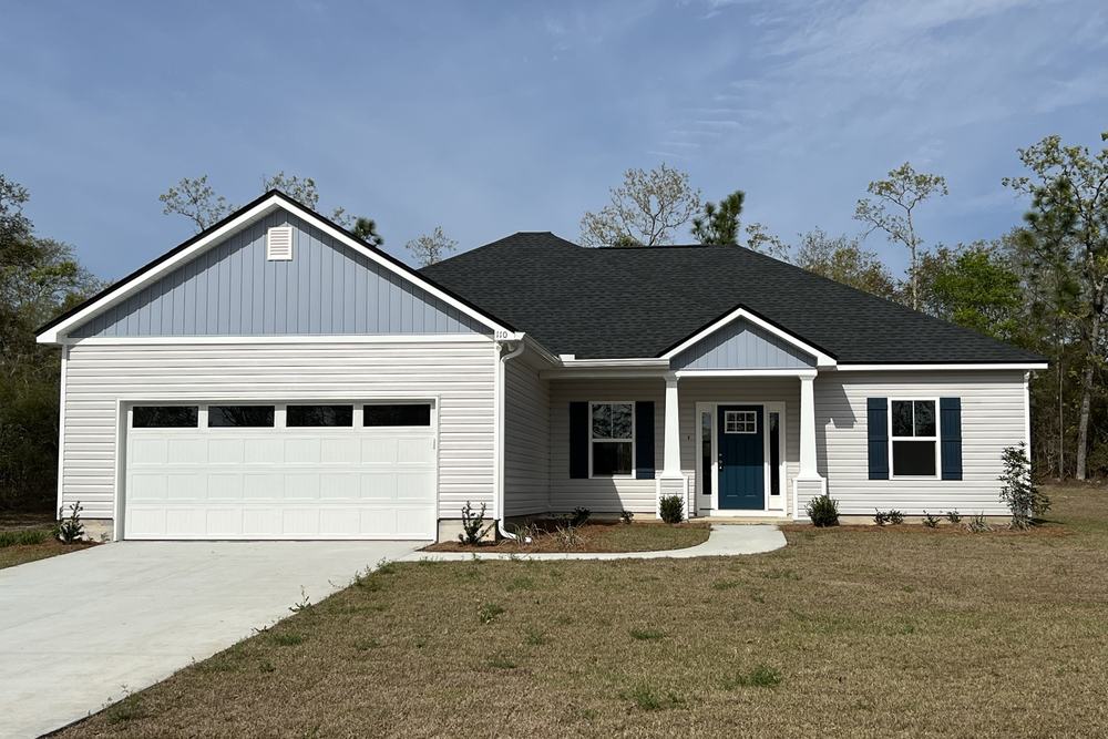 White farmhouse with an attached two-car garage