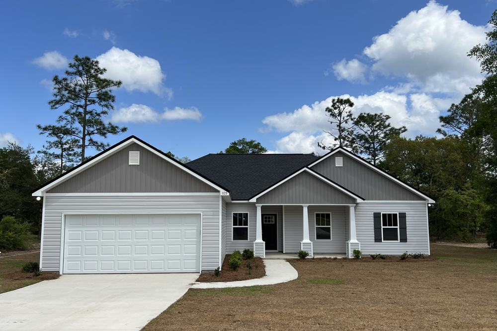 Grey ranch-style custom home with a two-car garage
