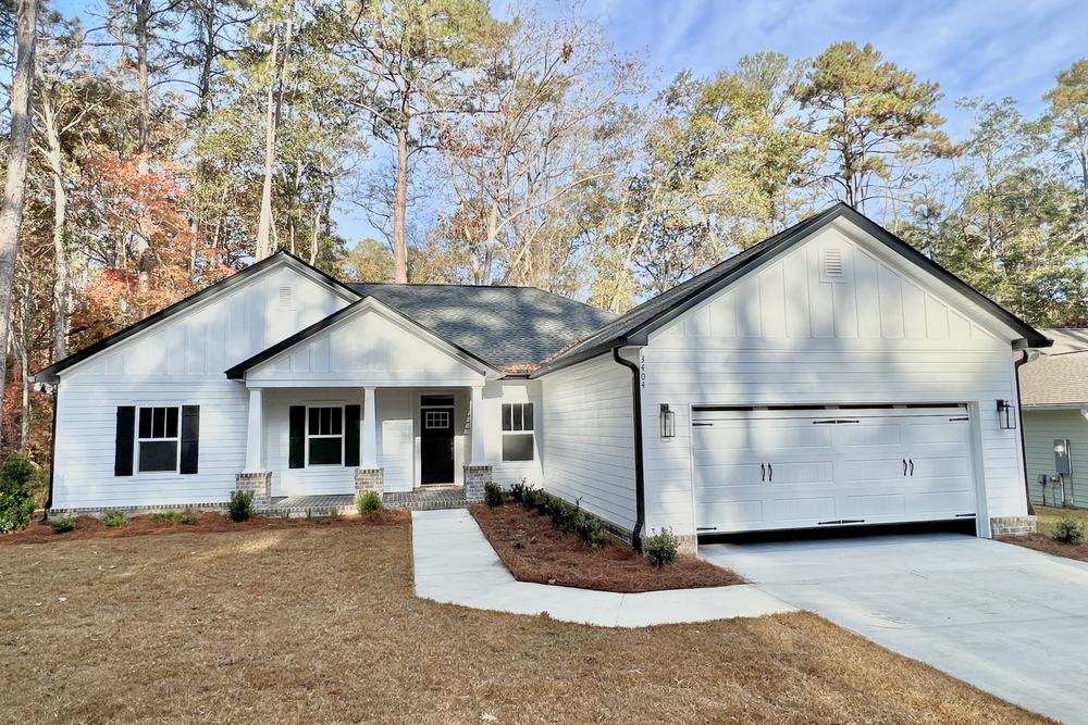 New construction home with a covered entry and attached garage