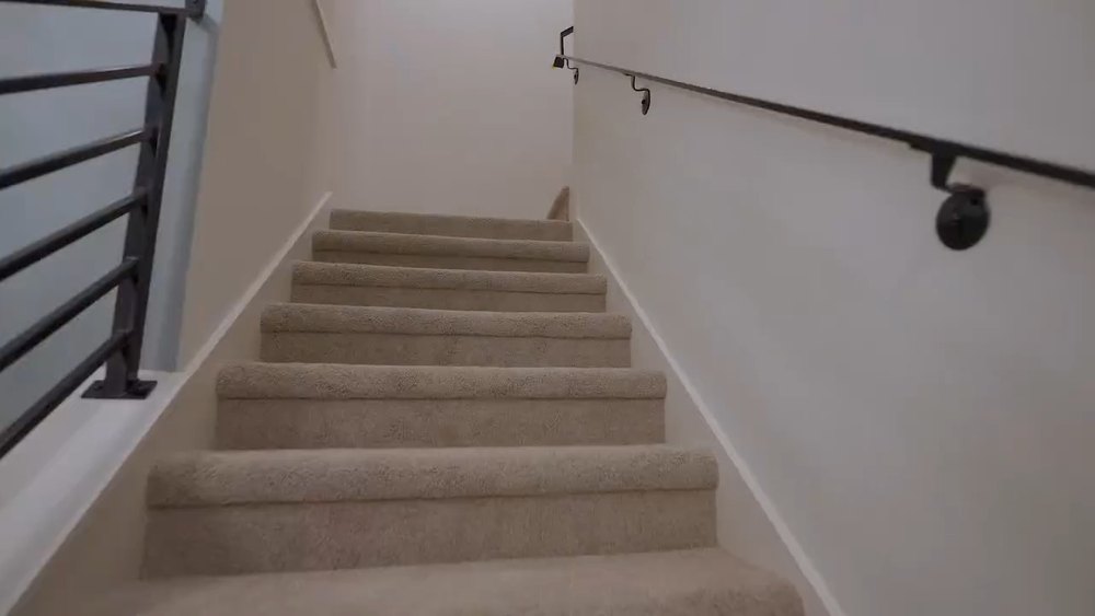 Staircase with a modern horizontal metal railing