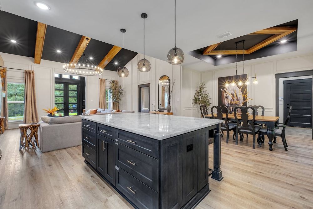 Kitchen with a dark island, pendant lighting and a beamed ceiling detail
