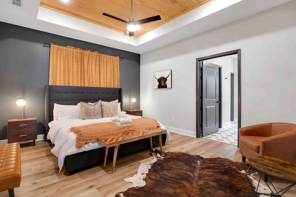 Primary bedroom with a stained wood tray ceiling