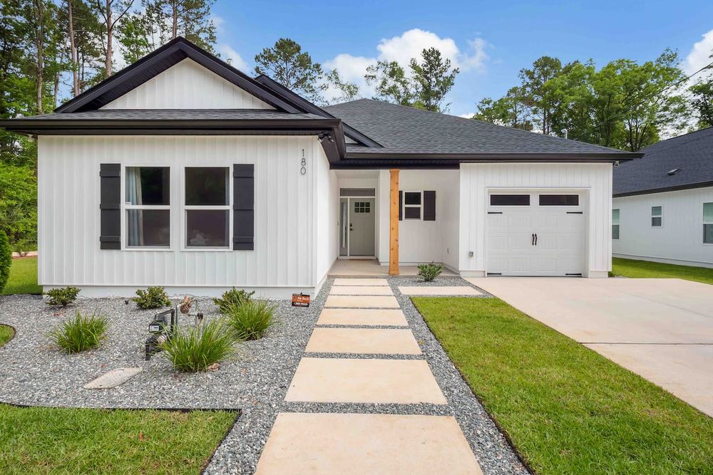 A modern mid century custom home with a single-car garage, built and designed by JSR Construction